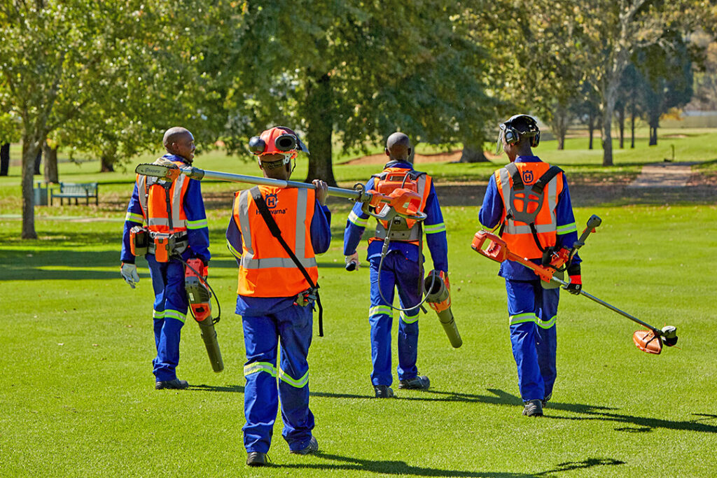 A team of groundskeepers on a golf course with Husqvarna battery equipment.